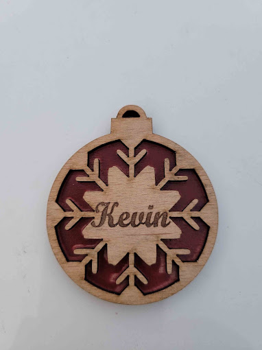 Personalised wooden snowflake ornament engraved with a name
