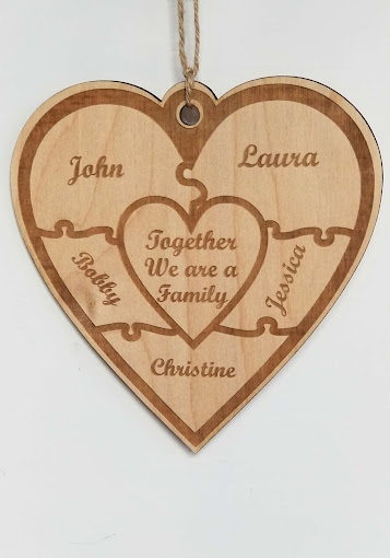 Engraved wooden heart plaque listing family names