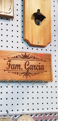 Engraved wooden plaque with a mounted bottle opener and family name