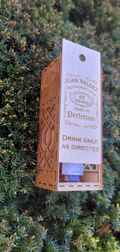 Engraved wooden gift tag on a wine bottle presentation box